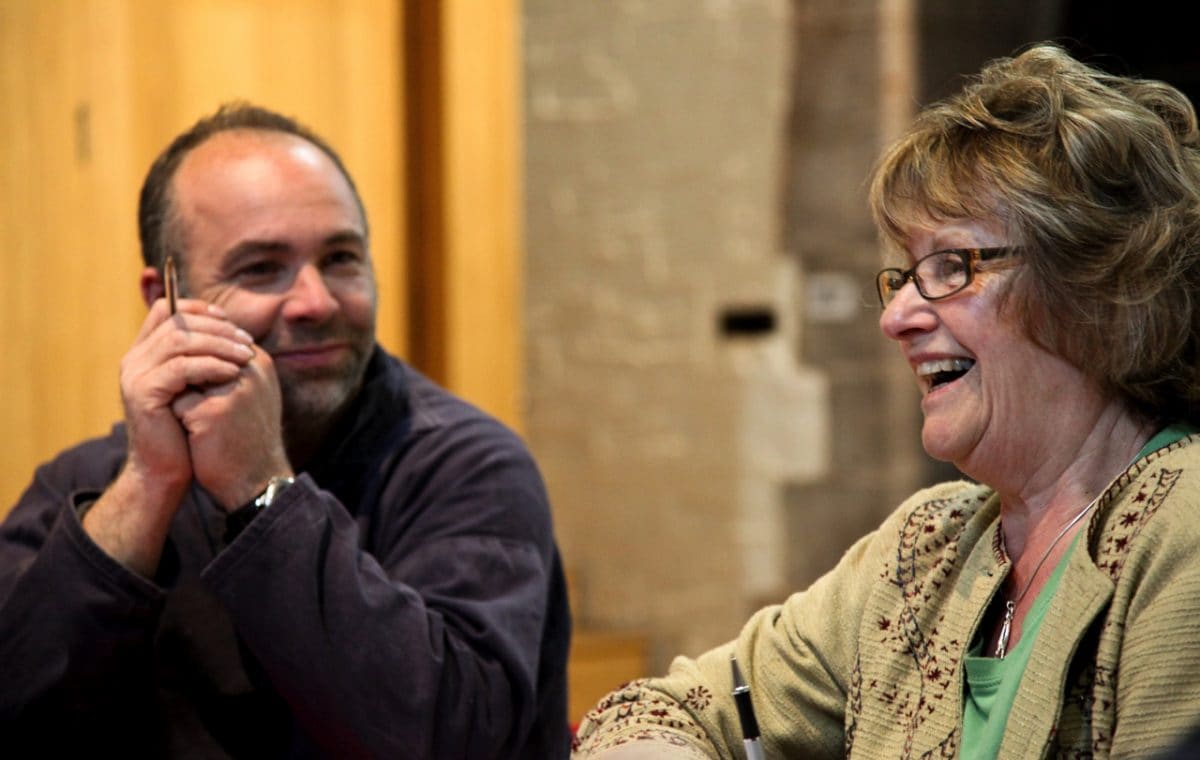 Man smiling at a woman who's laughing