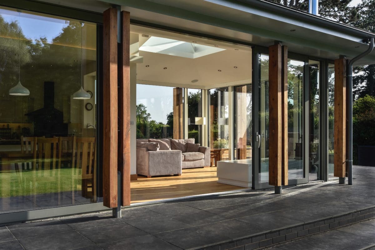 Sliding doors open to the home extension. The opening leads to the open plan living area, with additional sunlight let in through the roof opening. Communion Architects, Herefordshire.