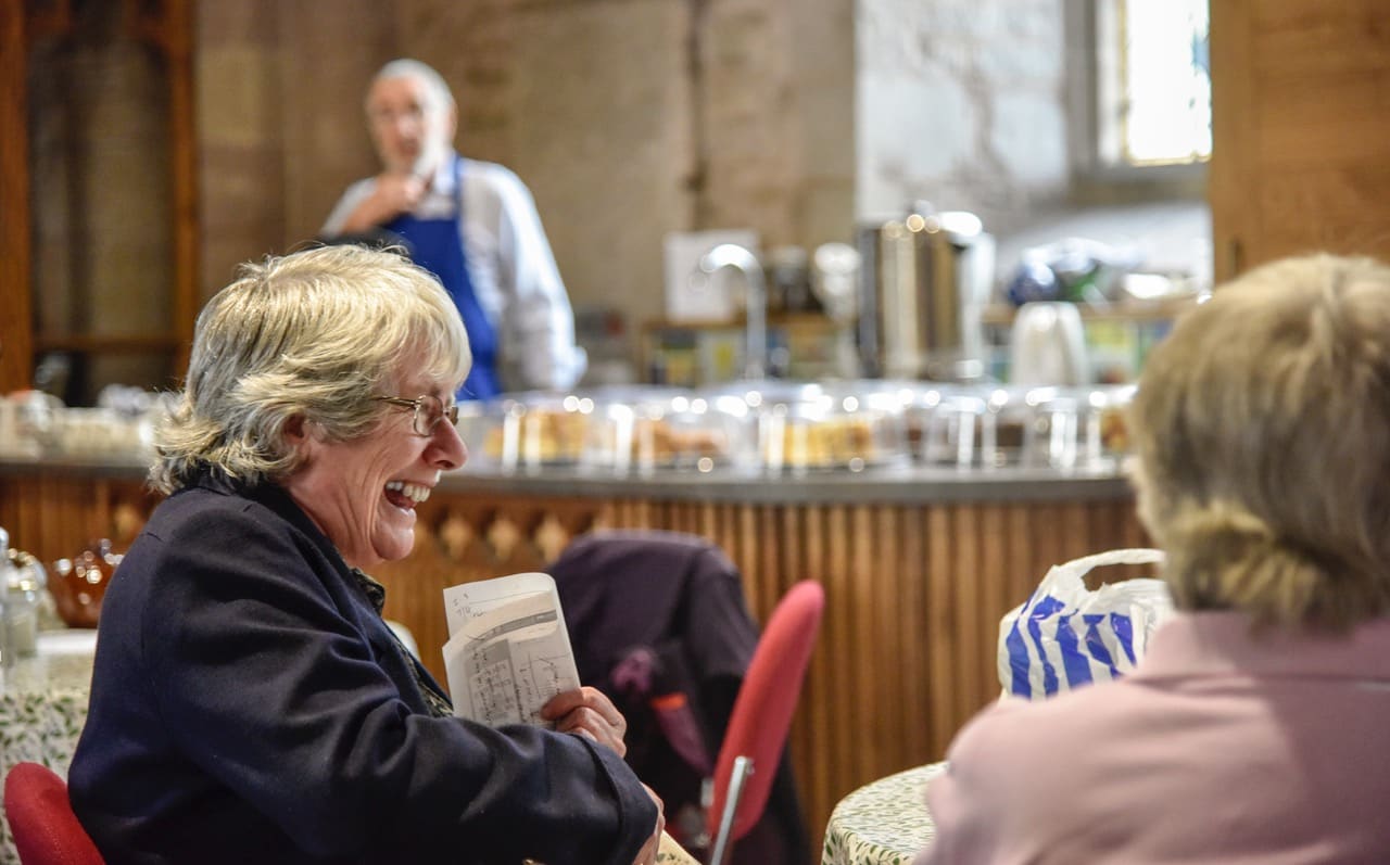 Two women enjoying the 'Take a Pew' cafe at St Michael's and All Angels. The church re-ordering allows the church to host such events.