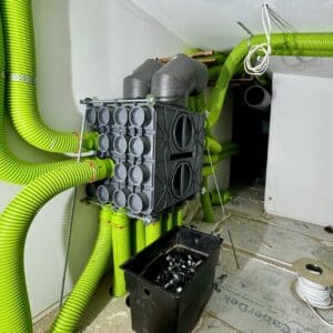 A space age looking sustainable ventilation unit with lime green ducting 'tentacles'. Communion Architects Hereford